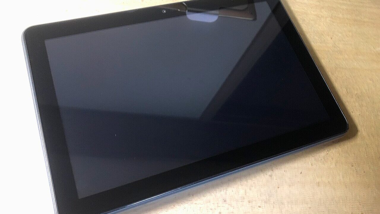Amazon Kindle Fire tablet lying on a wooden table